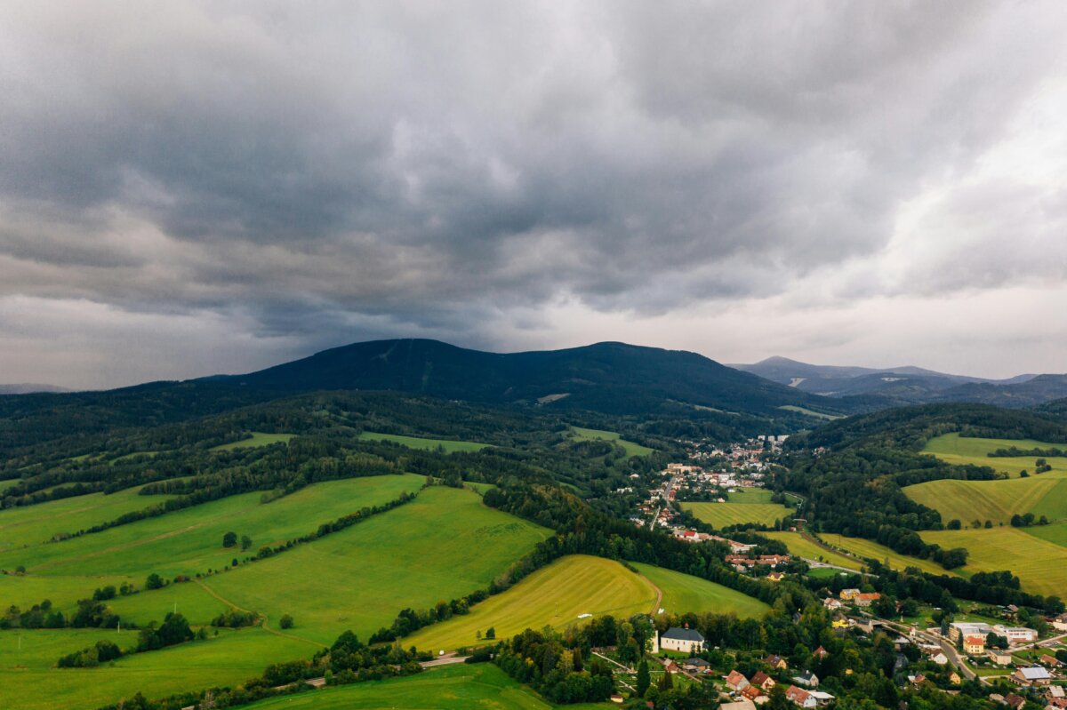 A stunning aerial view of lush fields and mountains in Pec pod Sněžkou, Czechia.
